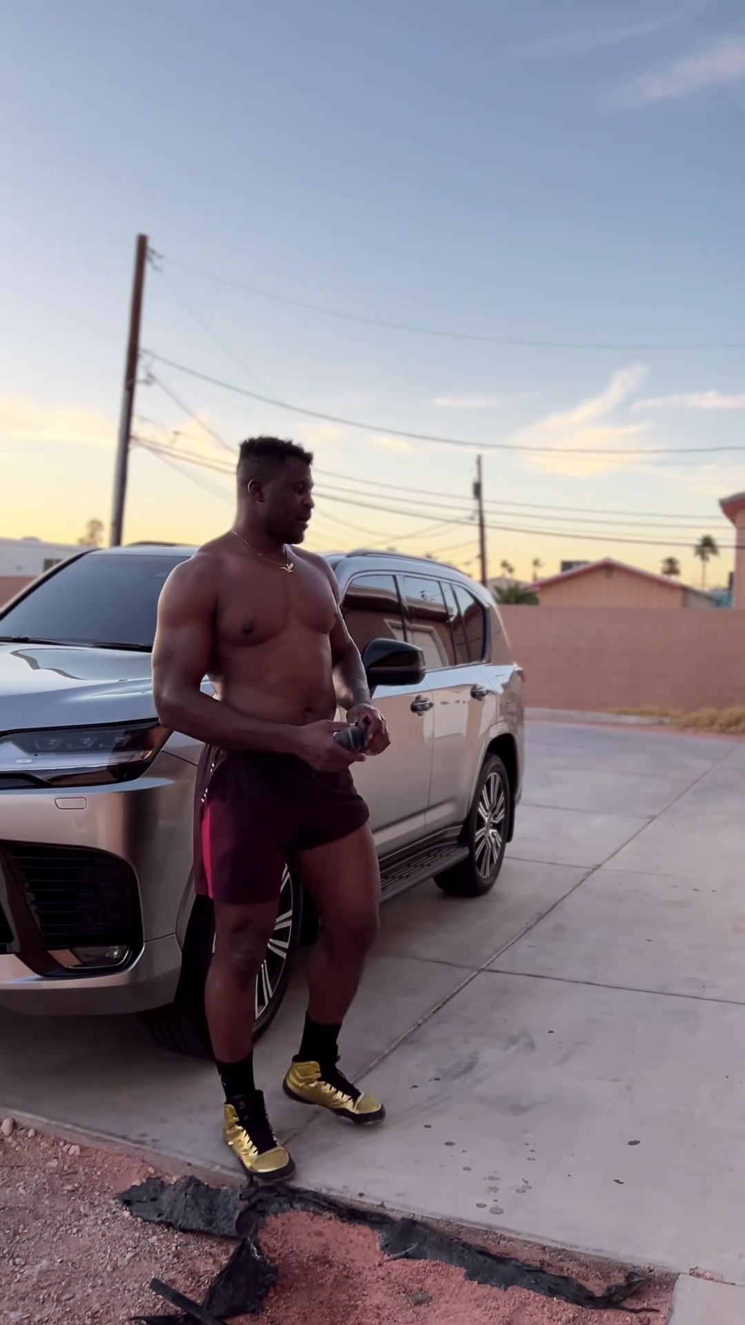 After a brutal training, Francis Ngannou showed off his ripped body as he drained litres of sweat from the top of his head.