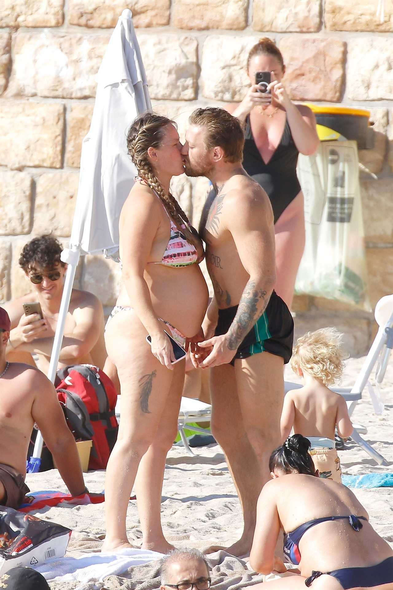 Conor McGregor and his pregnant fiancée Dee Devlin show PDA on French Beach