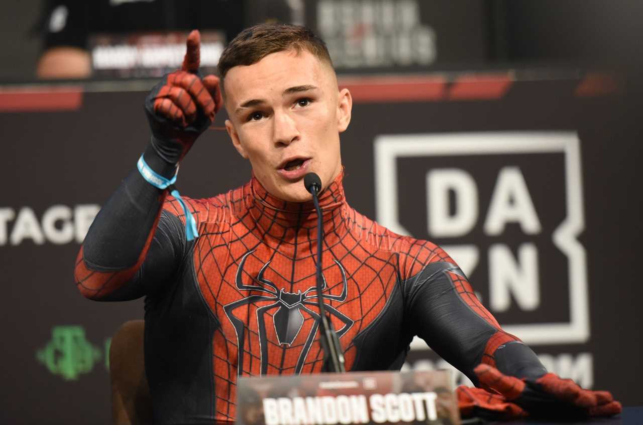 Brandon Scott, a'scrawny' nerd, dresses up as Spider-Man for a press conference and makes jokes about his manhood size compared to Anthony Joshua