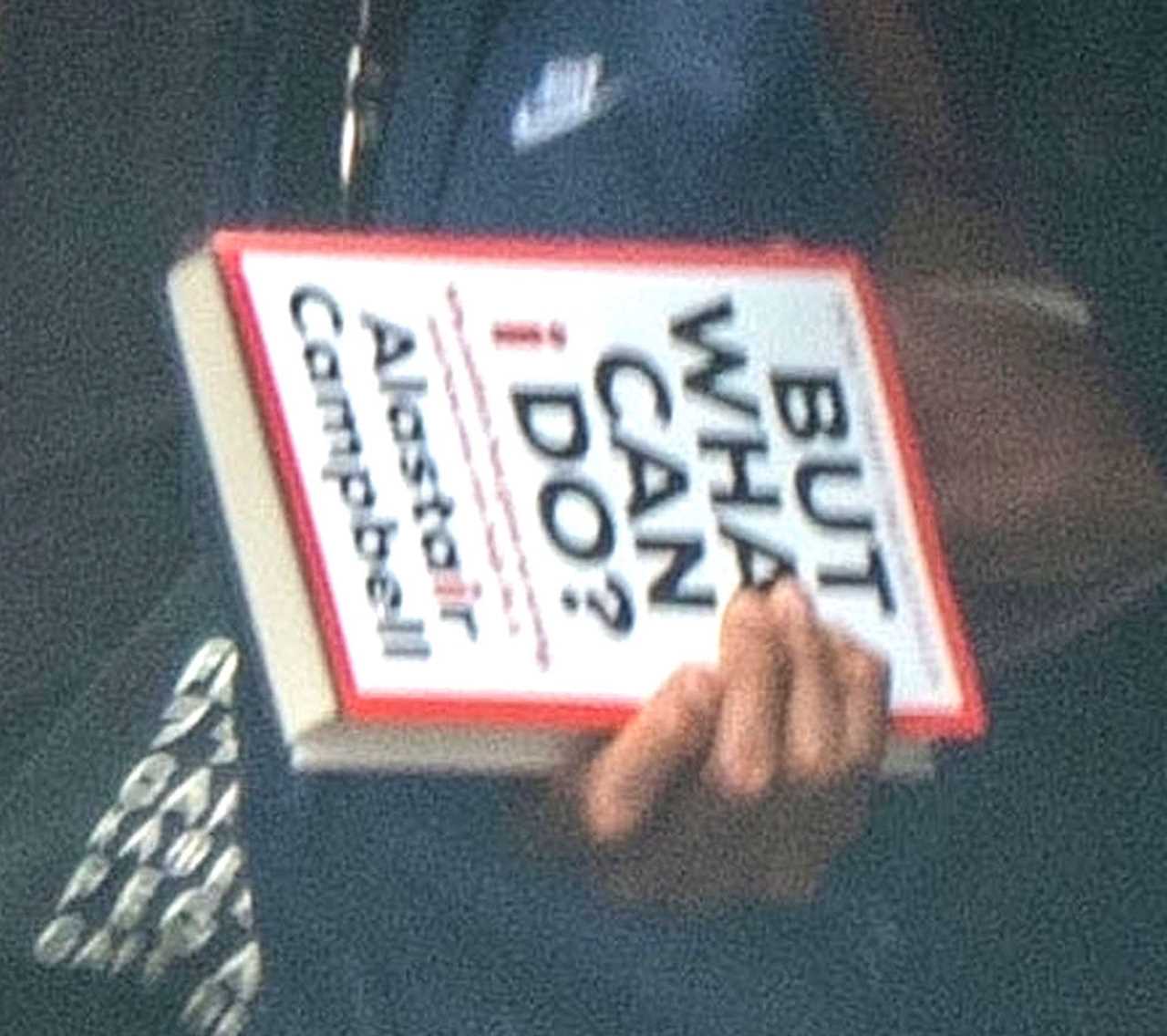 Anthony Joshua seen with a politics book while he meets his fans outside a restaurant