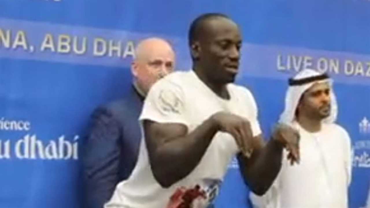 Fans are baffled by the bizarre weigh-in of a boxer who pretends to be a dino.