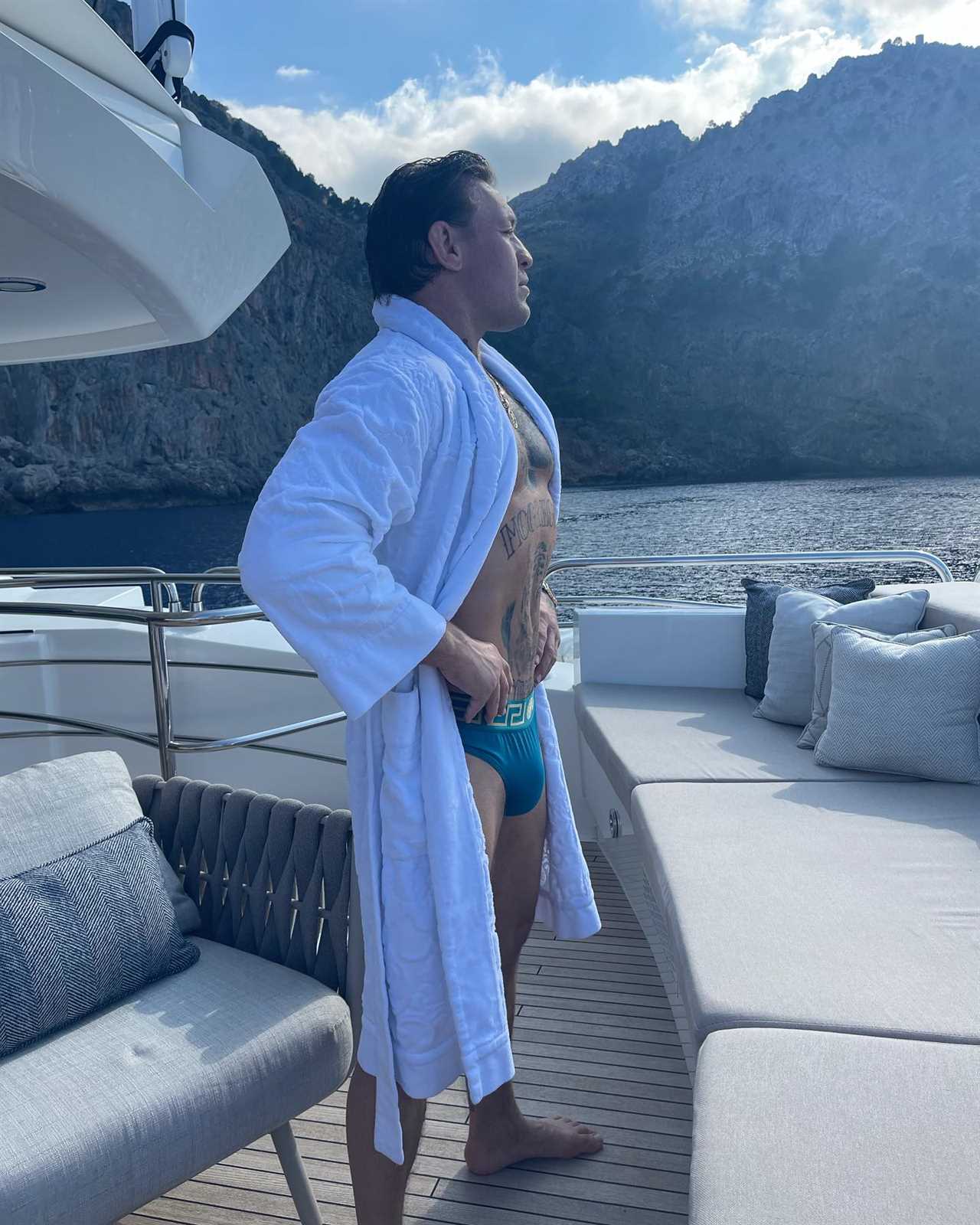Conor McGregor relaxes on his PS2.7m Lamborghini Yacht with budgie smugglers and dressing gowns while on holiday with family.