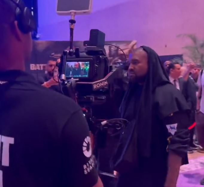 Kanye West's appearance in a mystery Premier League shirt for Tyson Fury and Francis Ngannou has left fans baffled