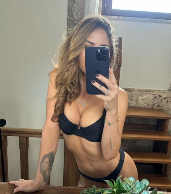Brittney Palmer Flaunts Sideboob in Topless Christmas Photo as Fans Speculate About Her Fate on the 'Naughty List'