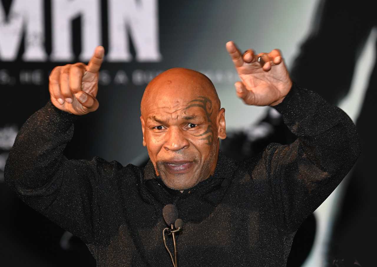 Madalina Ghenea, a Tennis WAG, poses with Mike Tyson during a Movie Event
