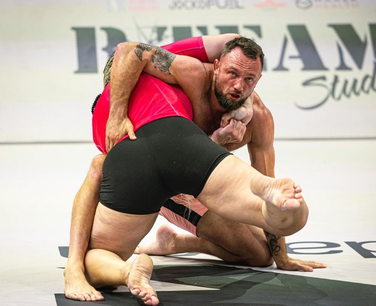 Male Fighter Chokes Out Female Opponent in Controversial Intergender Grappling Match